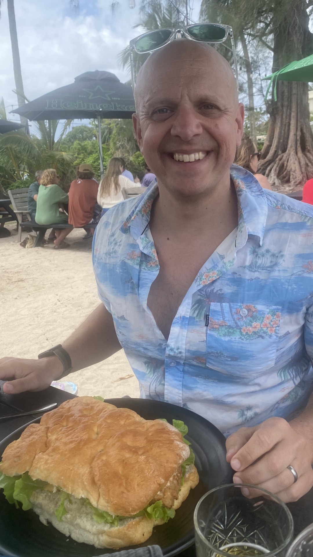 James smiling at an outdoor café