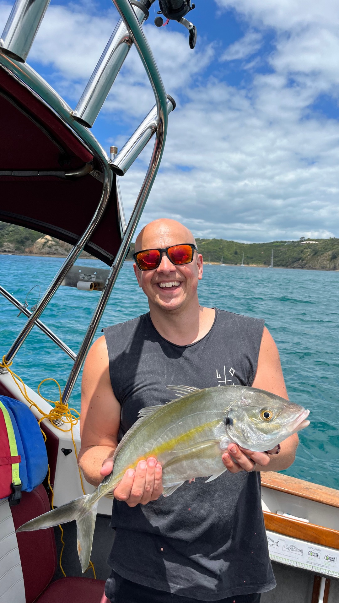 James holding a fish during time away from the studio